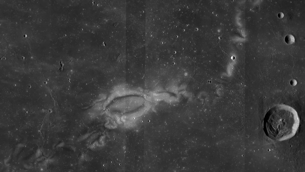 a light colored patchy area on the moon near some craters