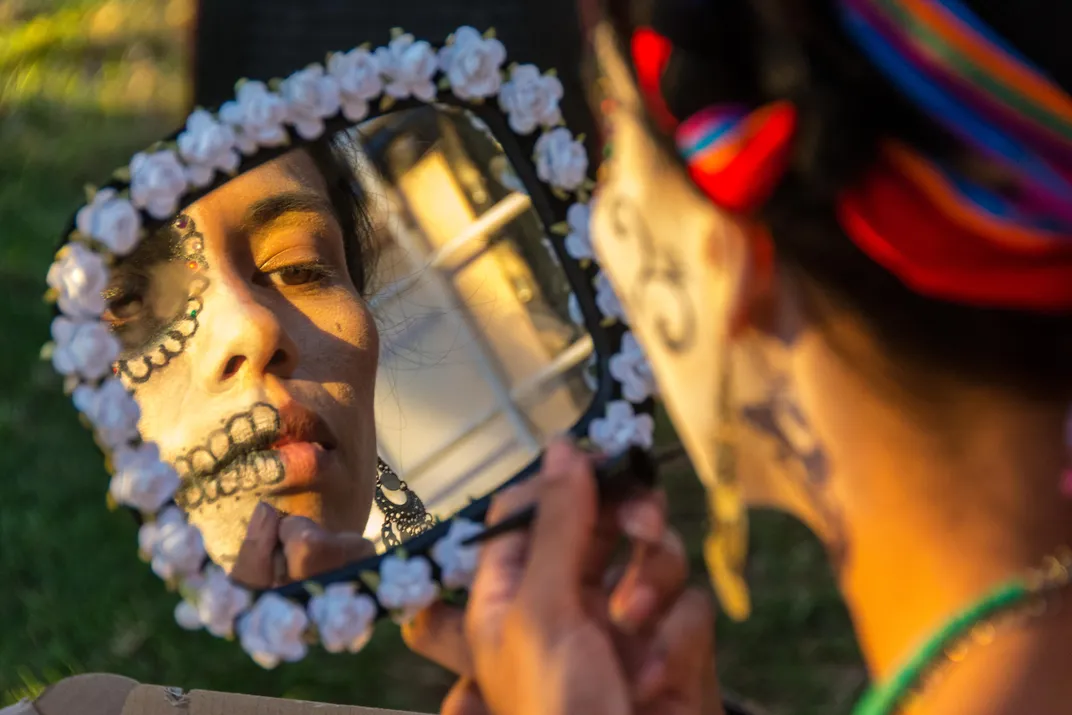 A woman paints her face