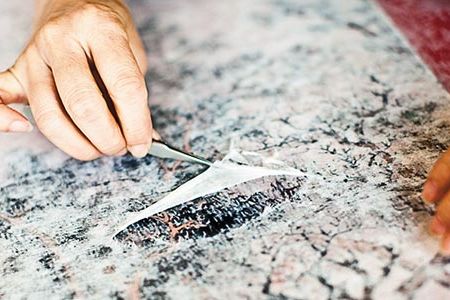 After Xiangmei Gu takes off the backing, she saves the brittle fragments in her record books, which date back two decades and line the shelves in her office.
