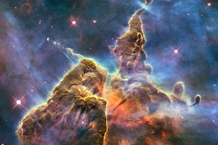 The "Mystic Mountain" image released for the Hubble's 20th anniversary showcases a three-light-year tall pillar of gas and dust stretching out of the Carina nebula. Mostly made of cool hydrogen, the structure is created by stars releasing jets of gas, which is worn away by radiation from other nearby stars, giving it its eroded shape.