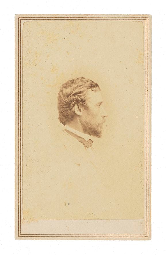 Formal studio photograph portrait of Sanford Robinson Gifford. He is in profile facing right, wearing a white suit and black bow tie. Image is cropped from his elbow up. 