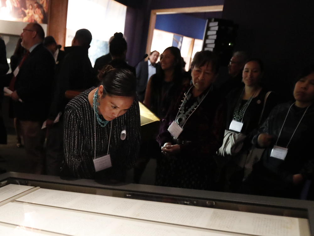 Representatives of the Navajo Nation read the original text of the Naaltsoos Sání, or Navajo Treaty of 1868, after its unveiling in the exhibition