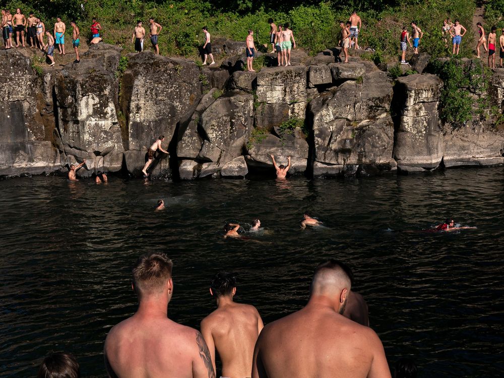 Cliff divers line up along the Clackamas River at High Rocks Park at on June 27, 2021 in Portland, Oregon