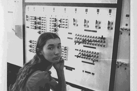 Dawn LeClair, member of the 1975 Wickenburg High School Math Club, sits in front of the paper clip computer.