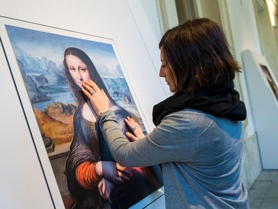 A Prado visitor touches a 3-D printed replica of a contemporaneous copy of the "Mona Lisa."