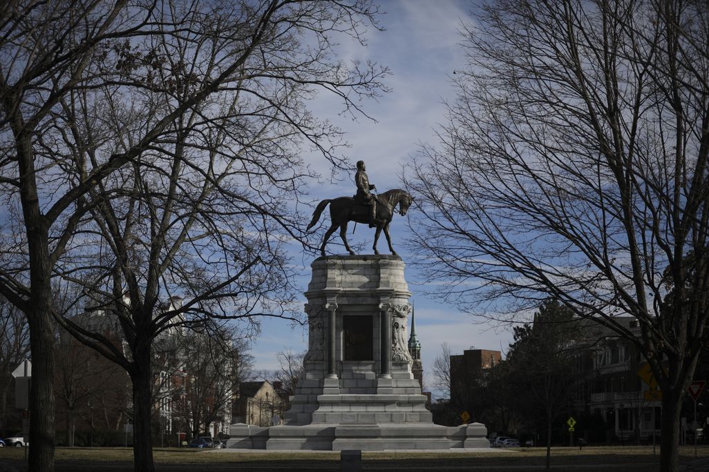 View of Richmond's Robert E. Lee monument, framed by trees, prior to its removal