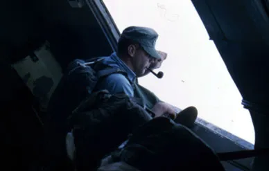 The author surveys the forbidding Laotian terrain from a C-46.
