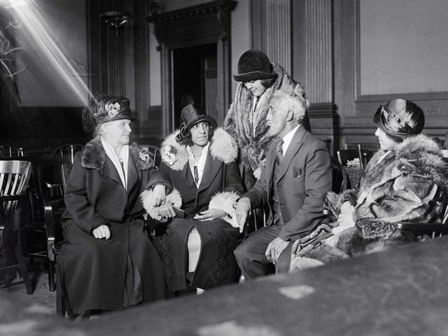 Alice Beatrice Rhinelander, n&eacute;e Jones (seated at center), looks at her father, George Jones, as they await the verdict in the&nbsp;Rhinelander v. Rhinelander&nbsp;case.