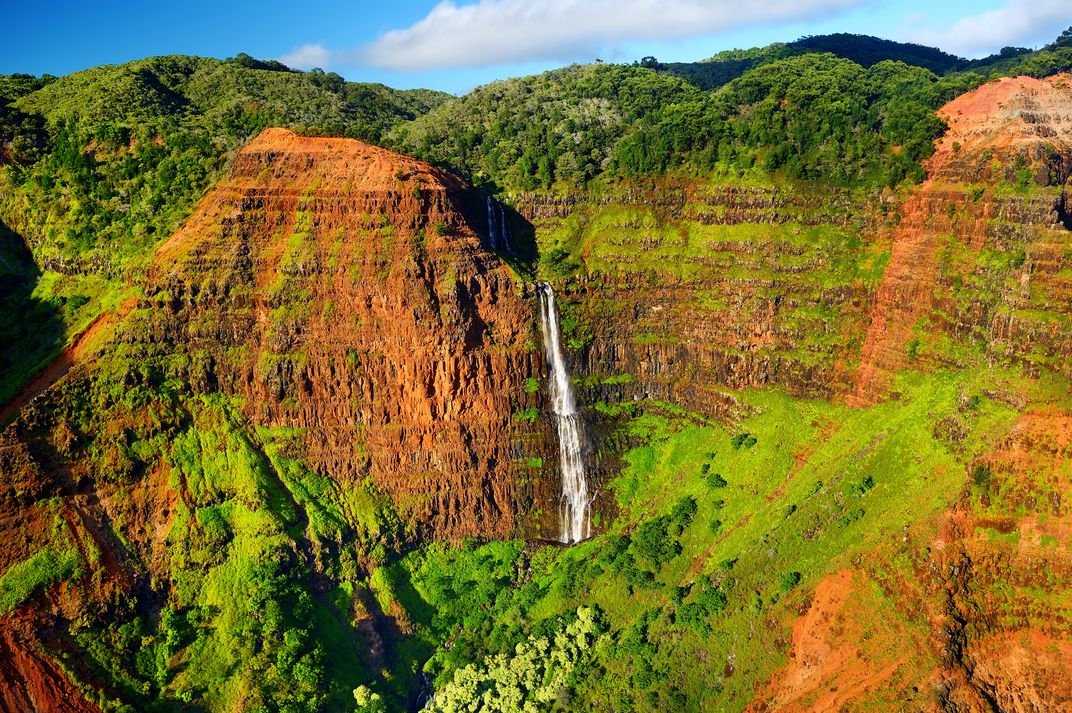 View of a waterfall hiking Waimea Canyon, Kauai