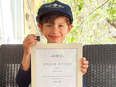 Six-year-old Imri Elya was awarded a "good citizenship" certificate for discovering a rare, small Canaanite tablet near an Israeli archaeological site. 