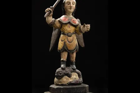 Carved wooden figure of San Miguel en Lucha con el Demonio