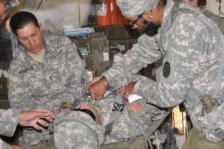 Capt. (Dr.) Tejdeep Singh Rattan (right) checks in a patient during the triage portion of an exercise during the Basic Officer Leadership Course at Camp Bullis, Texas in 2010. Rattan was the first Sikh allowed to keep his articles of faith while in uniform in 23 years. 