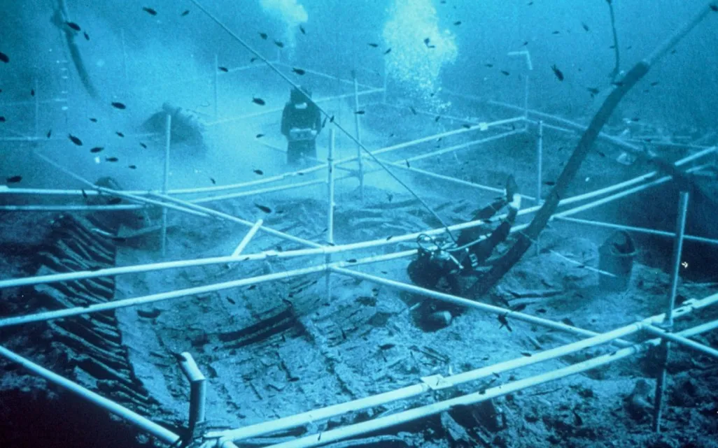 Underwater image of divers exploring a shipwreck