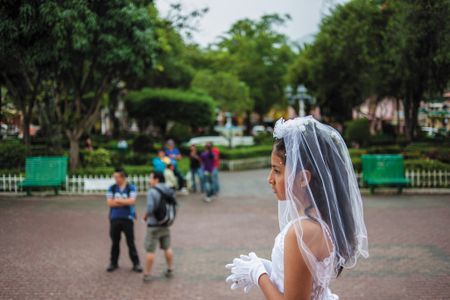 A local girl celebrates her first communion at the main church in Vilcabamba, an Ecuadorian village that retains its small-town feel despite an influx of foreigners in search of Shangri-La.
