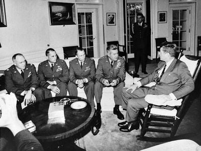 President Kennedy meets with Gen. Curtis LeMay and the pilots who discovered the Cuban missiles.