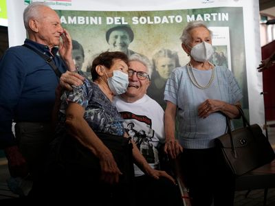 Veteran Martin Adler poses with Bruno (left), Mafalda (right) and Giuliana (center) Naldi. Thanks to social media and a dogged journalist, the 97-year-old reconnected with the three siblings after 77 years.