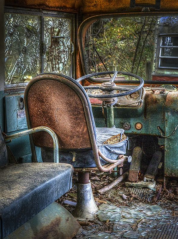 Bus Seat in font of a very old school bus thumbnail
