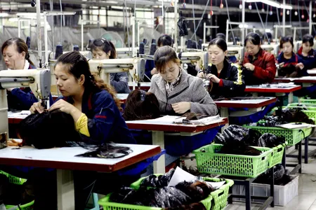 Female workers make wigs to be exported at a hair products factory in China's Sichuan province.