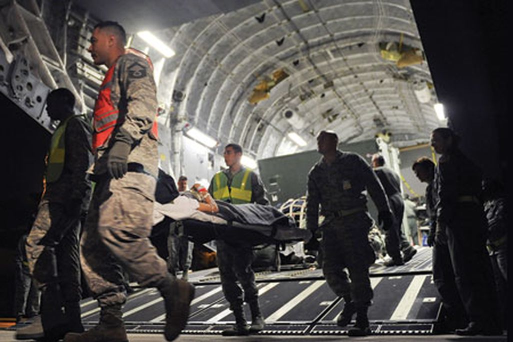 Wounded service members are taken off a C-17