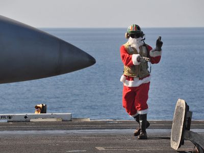 091225-N-8421M-103
NORTH ARABIAN SEA (December 25, 2009) Lt. Jon Sunderland dresses in a Santa suite while directing aircraft operations aboard the aircraft carrier USS Nimitz (CVN 68) Christmas Day.  Nimitz Carrier Strike Group is on a routine deployment to the region.  Operations in the U.S. 5th Fleet area of operations are focused on reassuring regional partners of the United States� commitment to security, which promotes stability and global prosperity.  (U.S. Navy photo by Mass Communication Specialist 1st Class David Mercil/Released)