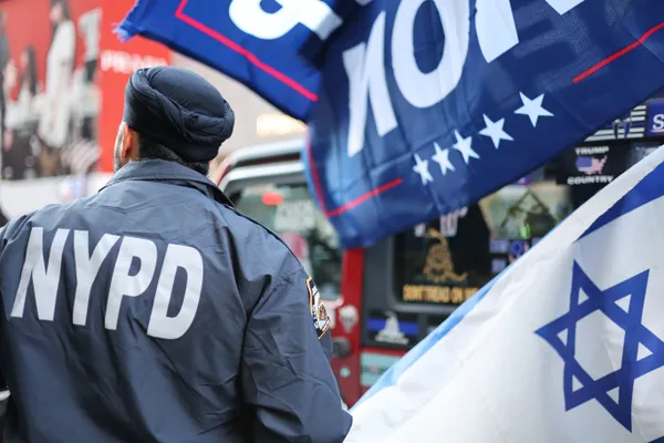 An NYPD officer directs traffic as a Trump caravan comes through Manhattan thumbnail