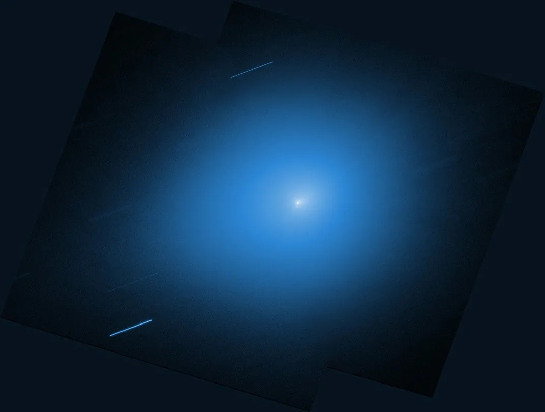 a bright blue glowing dot with white at its center and a couple of blue streaks around it
