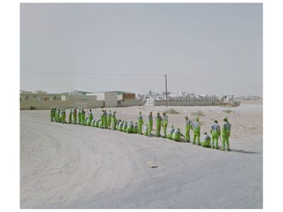 A line of men in green in the United Arab Emirates