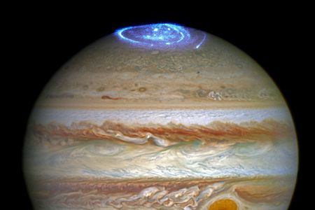 Ultraviolet images overlying a photo of Jupiter taken by the Hubble Space Telescope