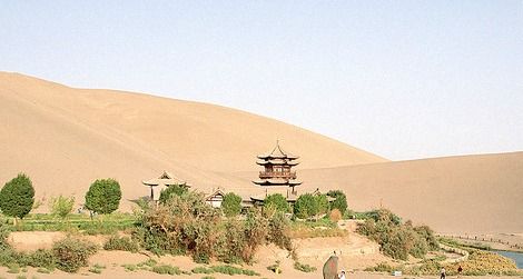 Tourists explore the Crescent Moon Spring along the historic Silk Road trade route.