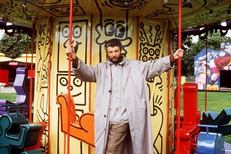 Luna Luna&#39;s creator,&nbsp;Andr&eacute; Heller, stands on a merry-go-round designed by Keith Haring in June 1987.