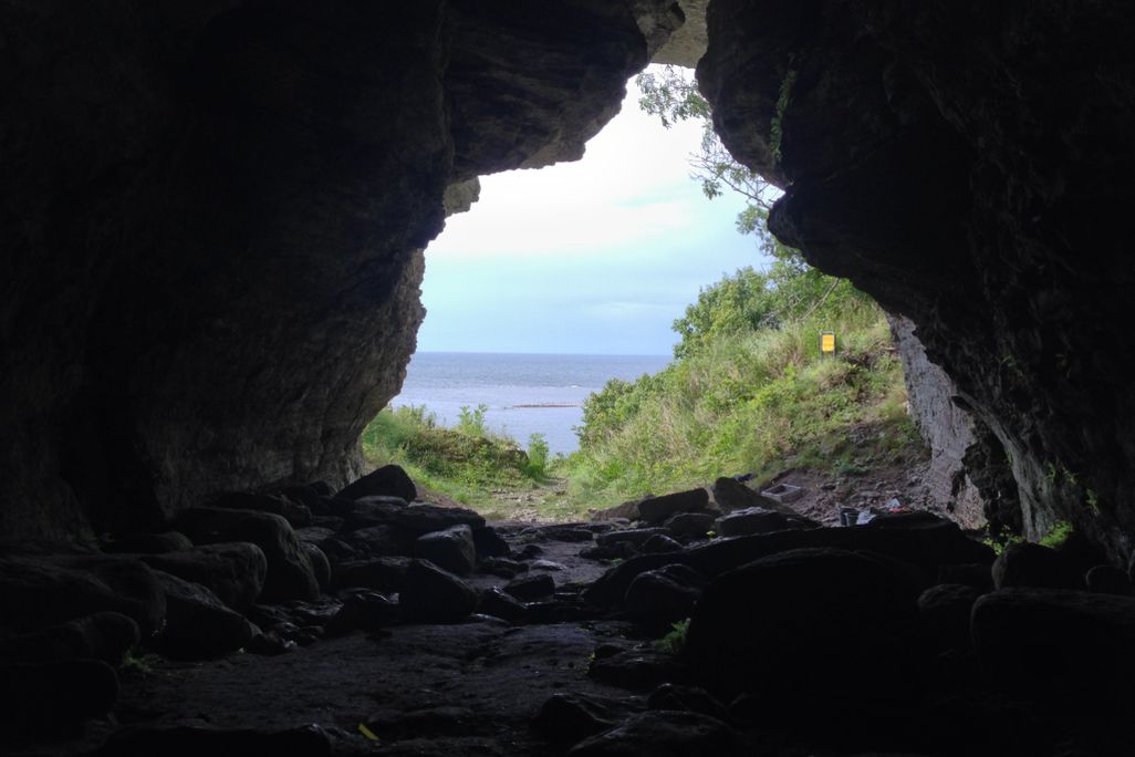 The view from inside a cave looking out at the sea