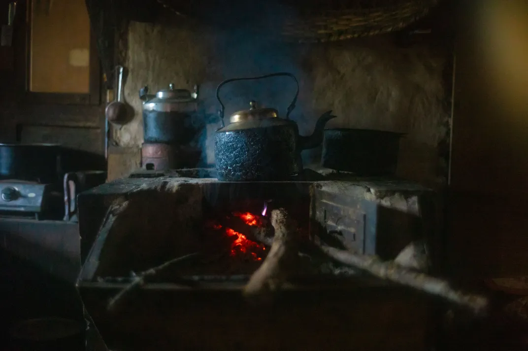 A fire glows in a wood-burning stove