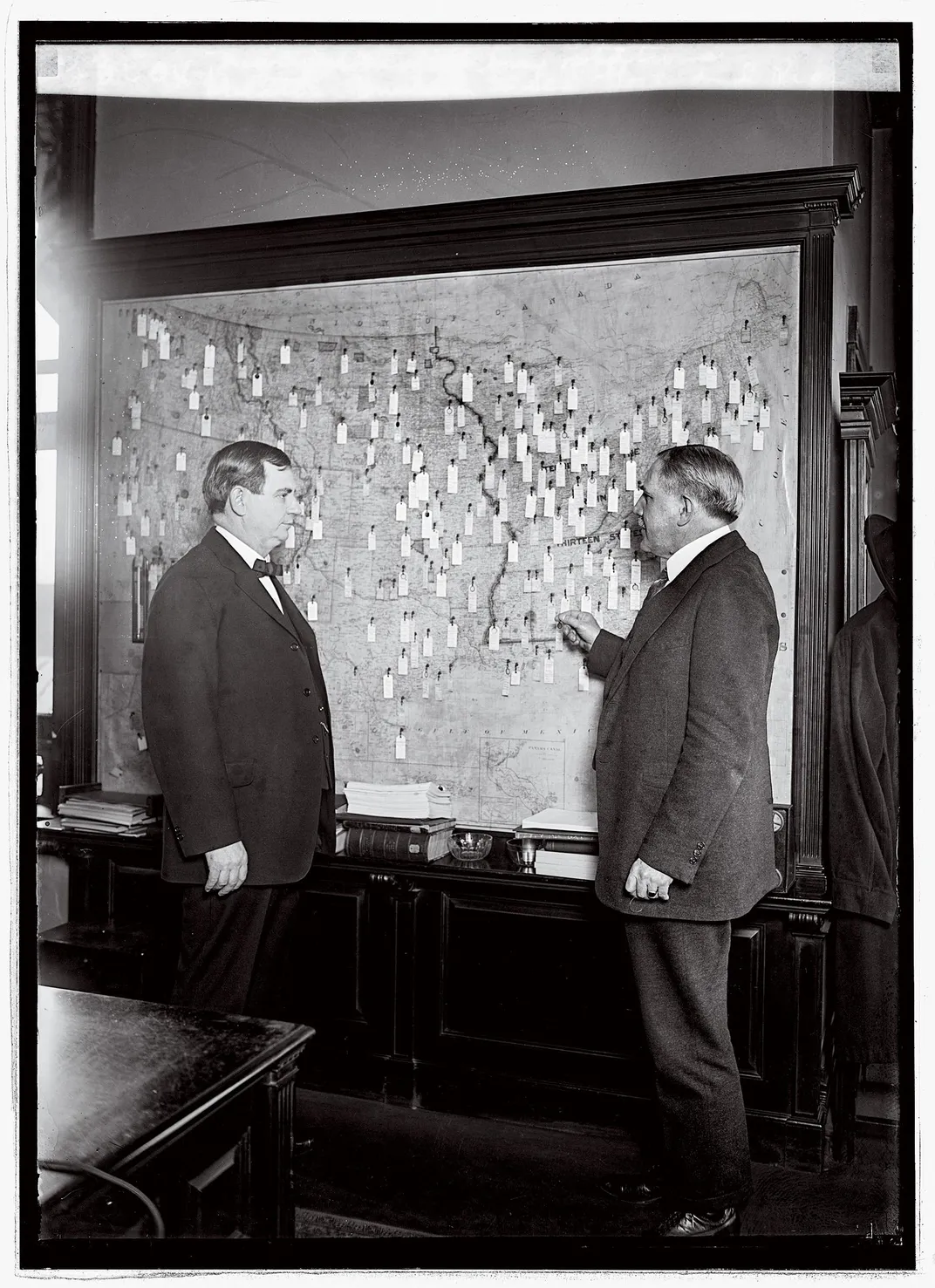 two men in front of a map