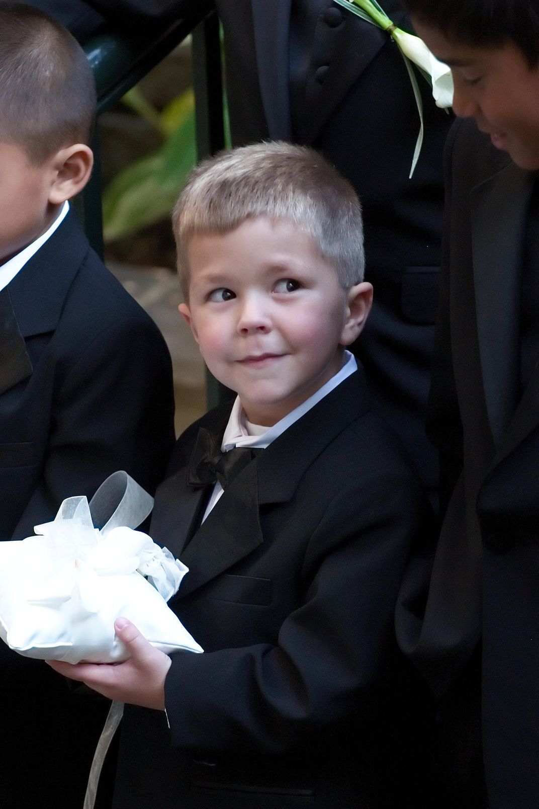 a-ring-bearer-waits-patiently-during-a-wedding-photo-shoot