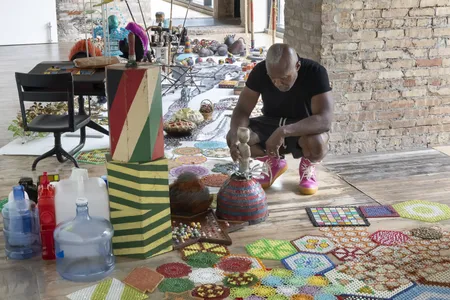 Nick Cave in his studio with objects featured in the "Mammoth" exhibition
