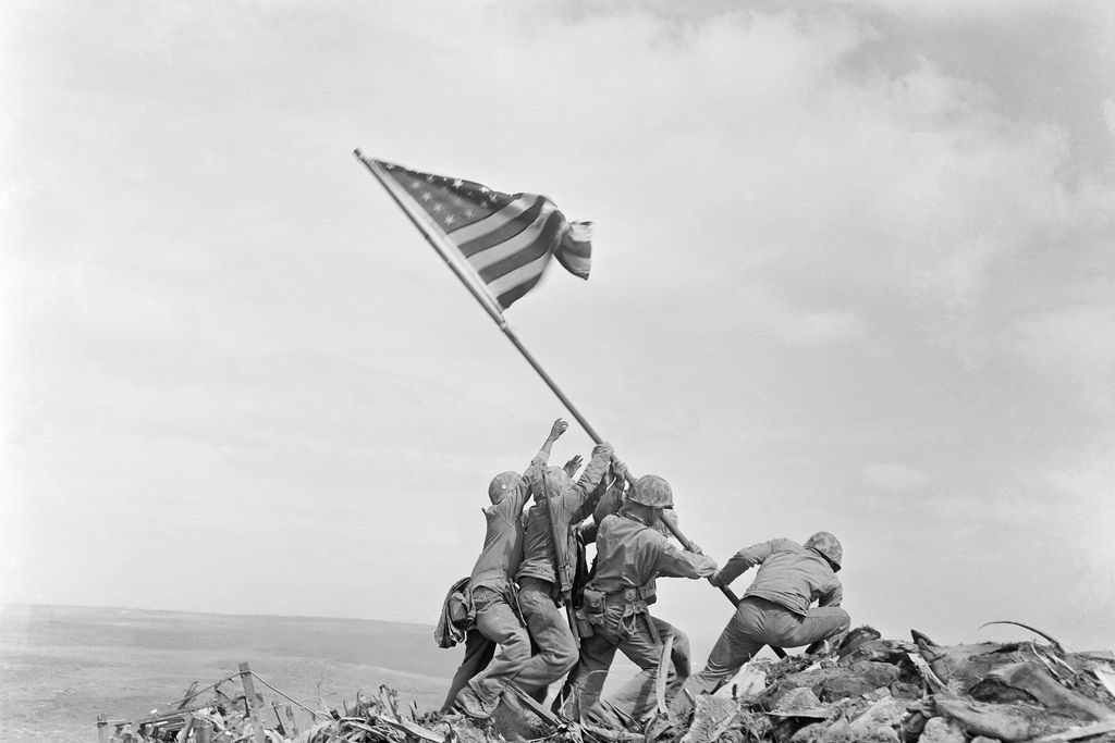 Soldiers raising American flag
