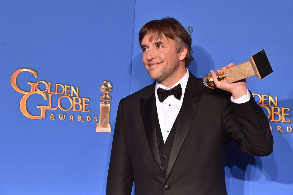 Richard Linklater holding a Golden Globe Award