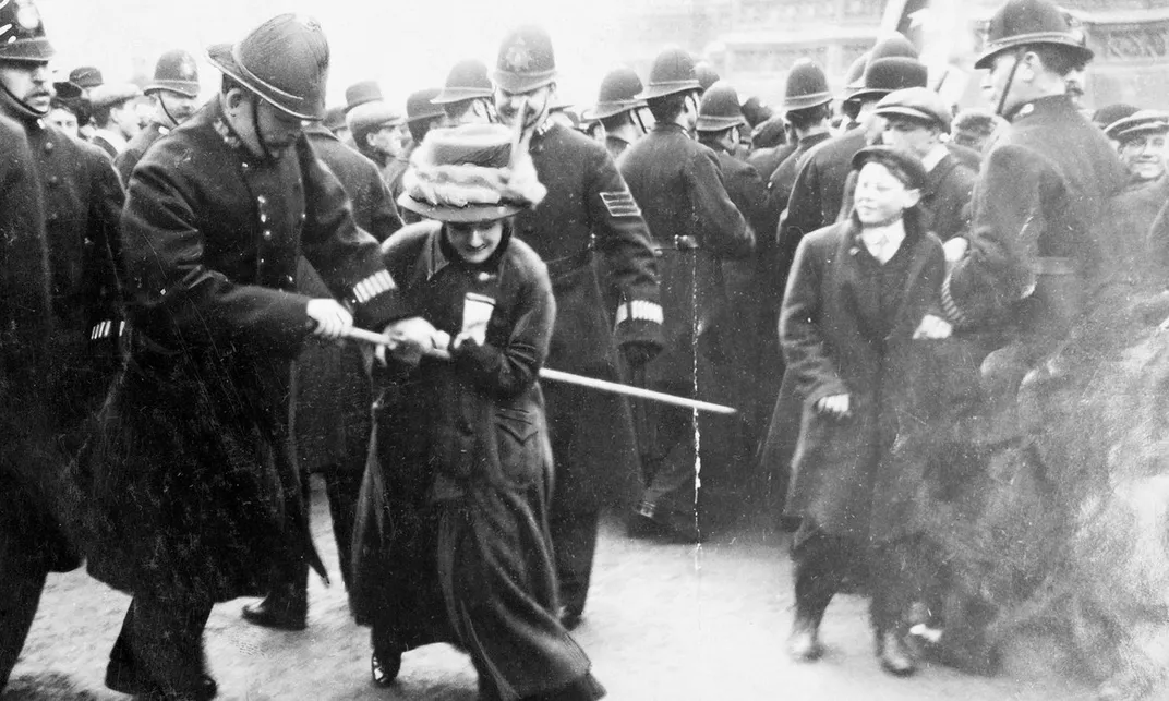 A policeman tries to seize a banner from a suffragette on Black Friday, November 18, 1910.
