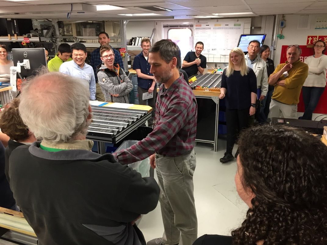 People talking in a cramped room.