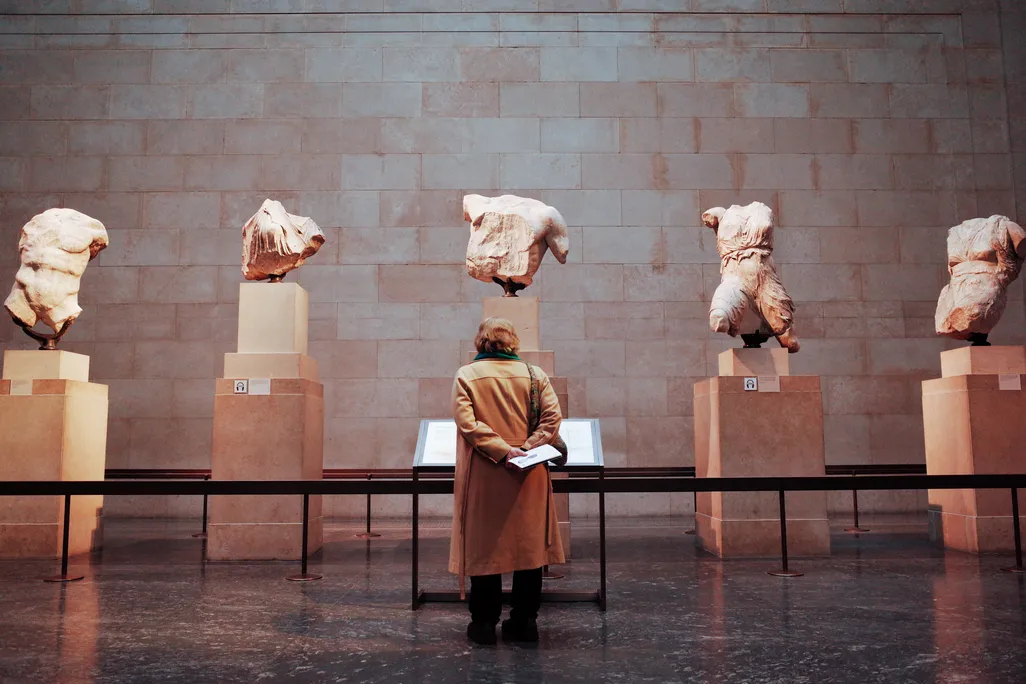 A woman looks at the Parthenon sculptures/Elgin marbles in the British Museum, London