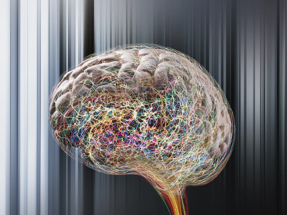 An artist's digital depiction of colorful, squiggly lines representing brain activity around an image of a brain