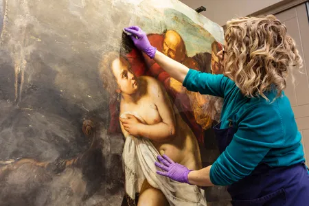 Conservator Adelaide Izat works on Susanna and the Elders, a painting newly reattributed to Artemisia Gentileschi.