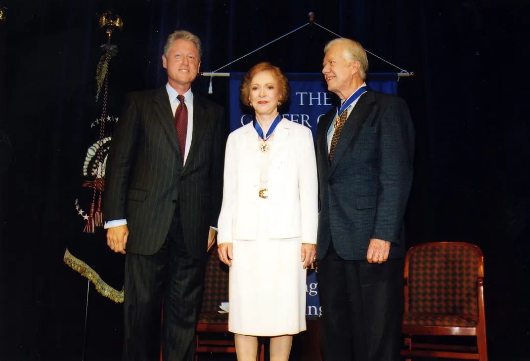 Bill Clinton presents Rosalynn and Jimmy with the Presidential Medal of Freedom in 1999.