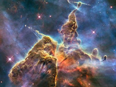 The "Mystic Mountain" image released for the Hubble's 20th anniversary showcases a three-light-year tall pillar of gas and dust stretching out of the Carina nebula. Mostly made of cool hydrogen, the structure is created by stars releasing jets of gas, which is worn away by radiation from other nearby stars, giving it its eroded shape.