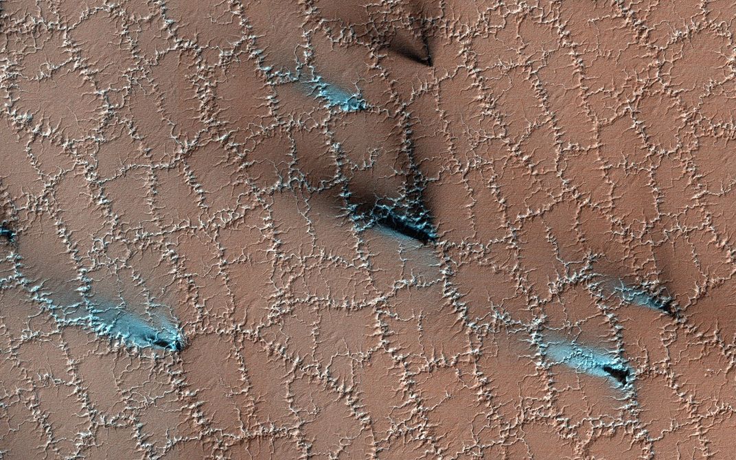 aerial shot of a grid formed by spindly lines on Mars's ground