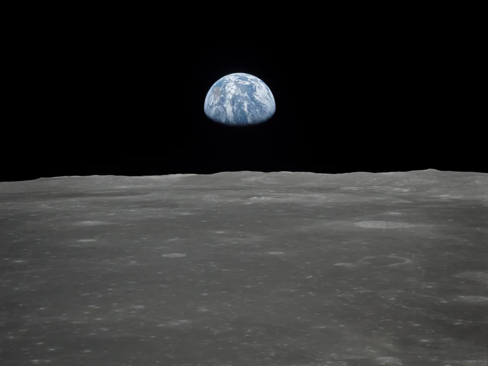 View of Earth rising over Moon's horizon taken from Apollo 11 spacecraft