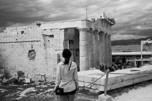 Young woman standing before an ancient building. thumbnail