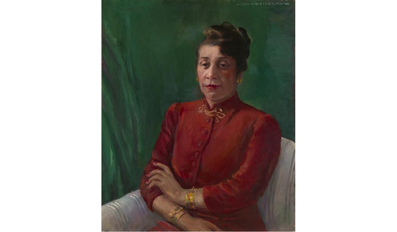 Distinguished in a high-collared, red shirt and gold jewelry, Alma Thomas wears her hair up and looks directly at the viewer. Her arms are crossed loosely, and she sits before a green background.