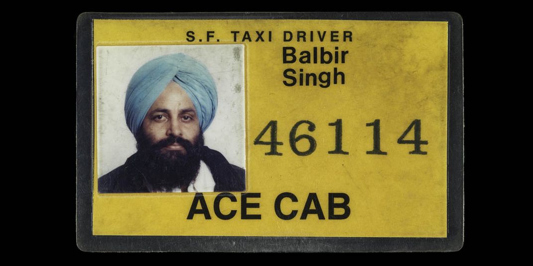 A yellow taxi license with a a picture of Sodhi