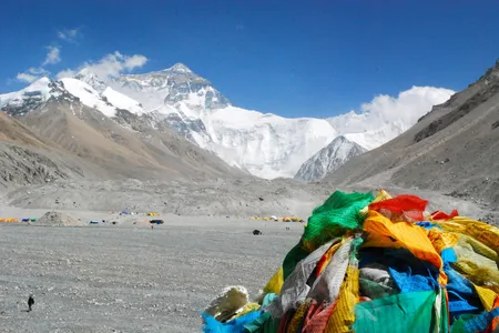 A pile of discarded prayer flags lays in front of Mount Everest, which claimed four lives in just four days over the weekend. 